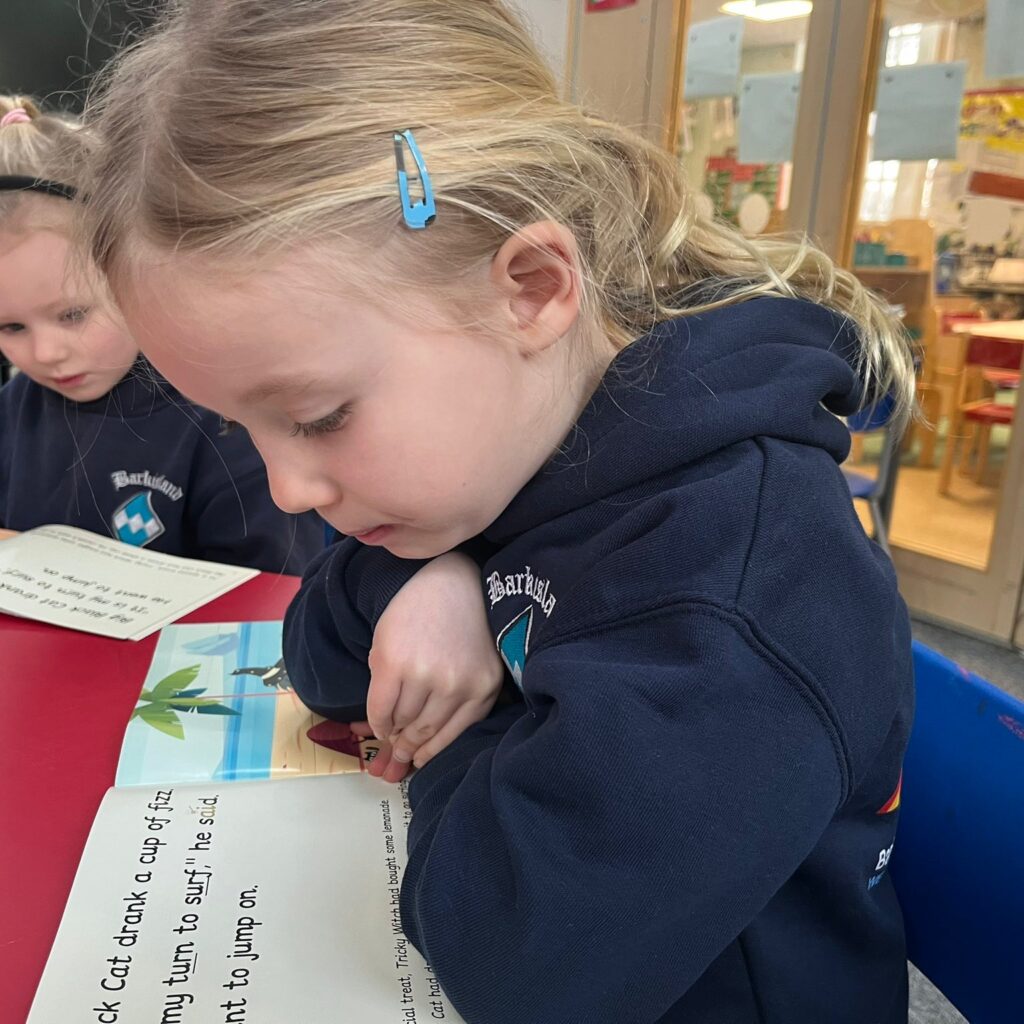 Child reading monster phonics books