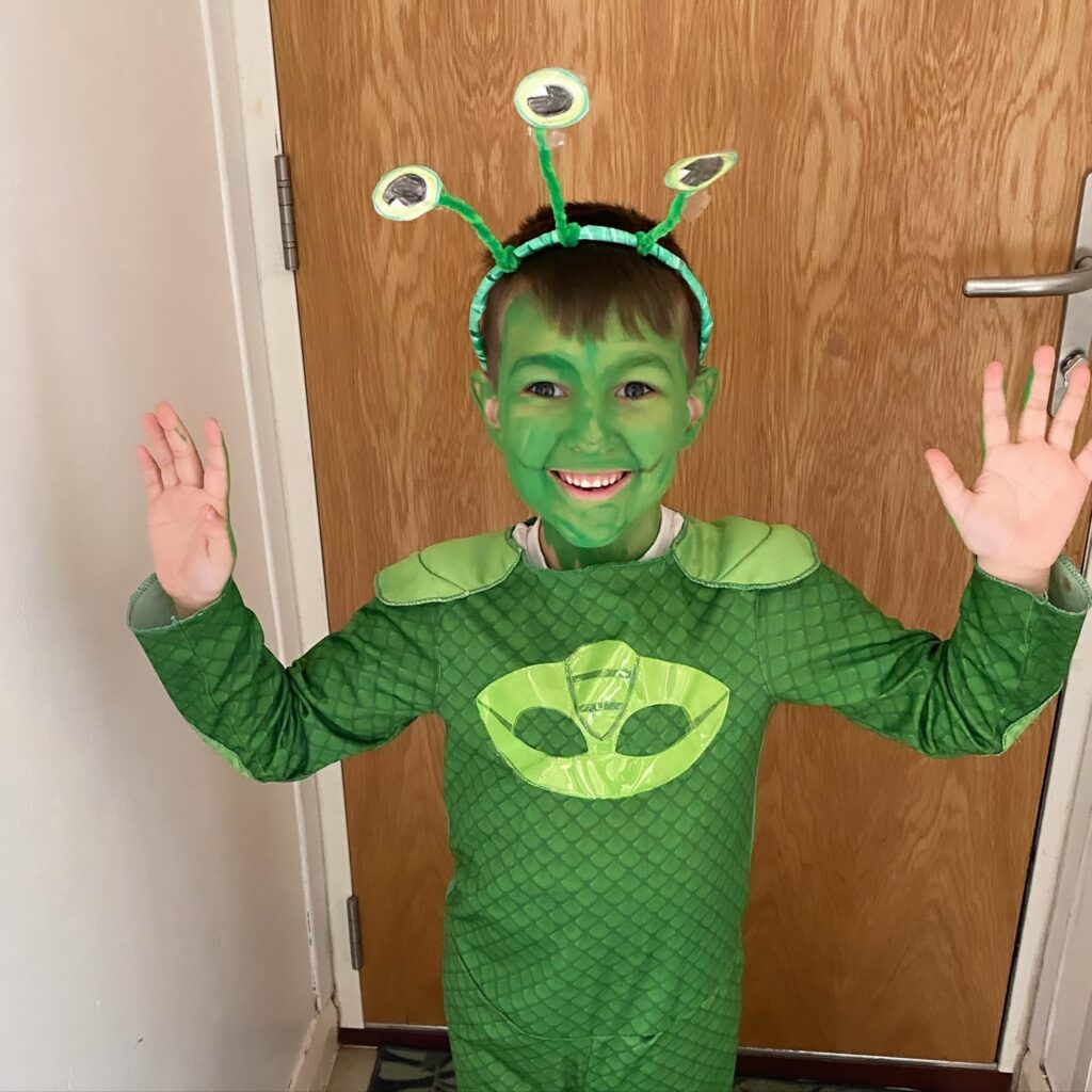 Child dressed up as green froggy