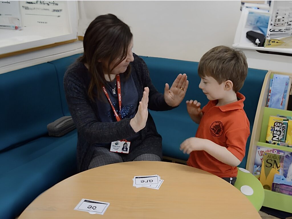 Image of teacher and child taking part in an intervention session