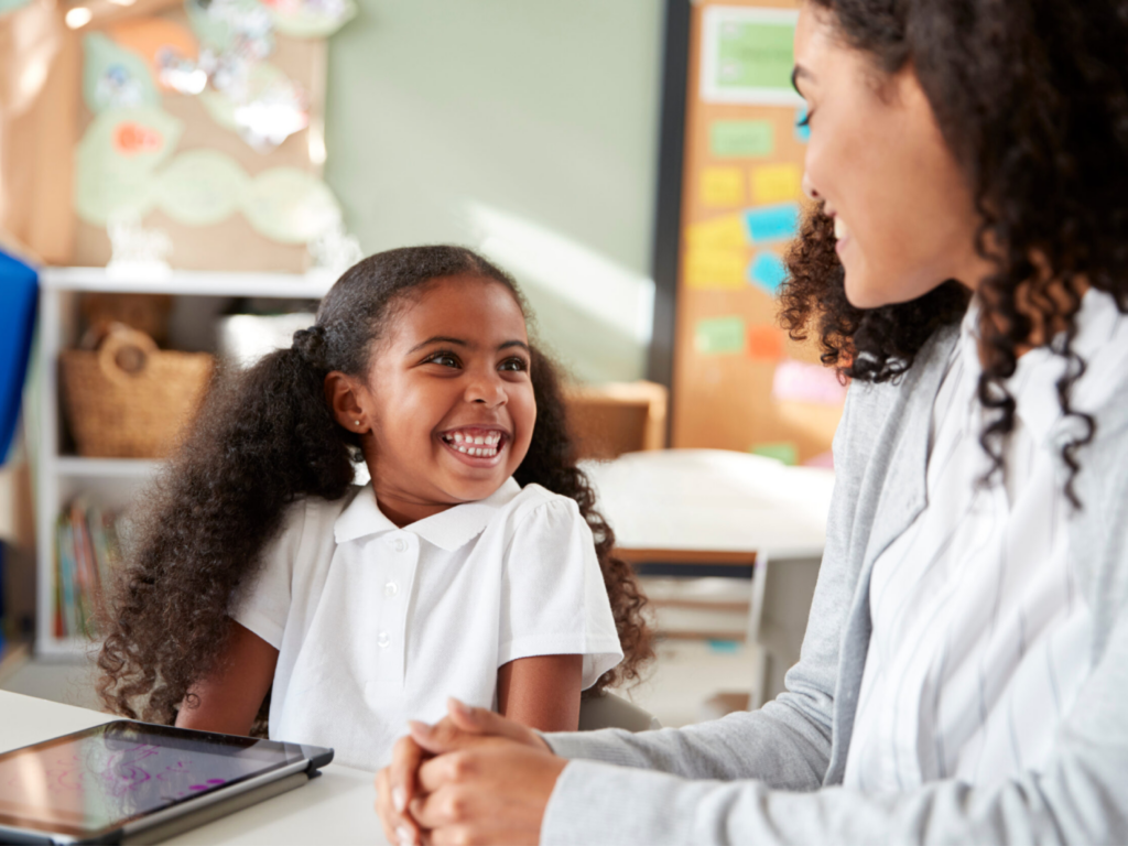 Child and teacher happily learning