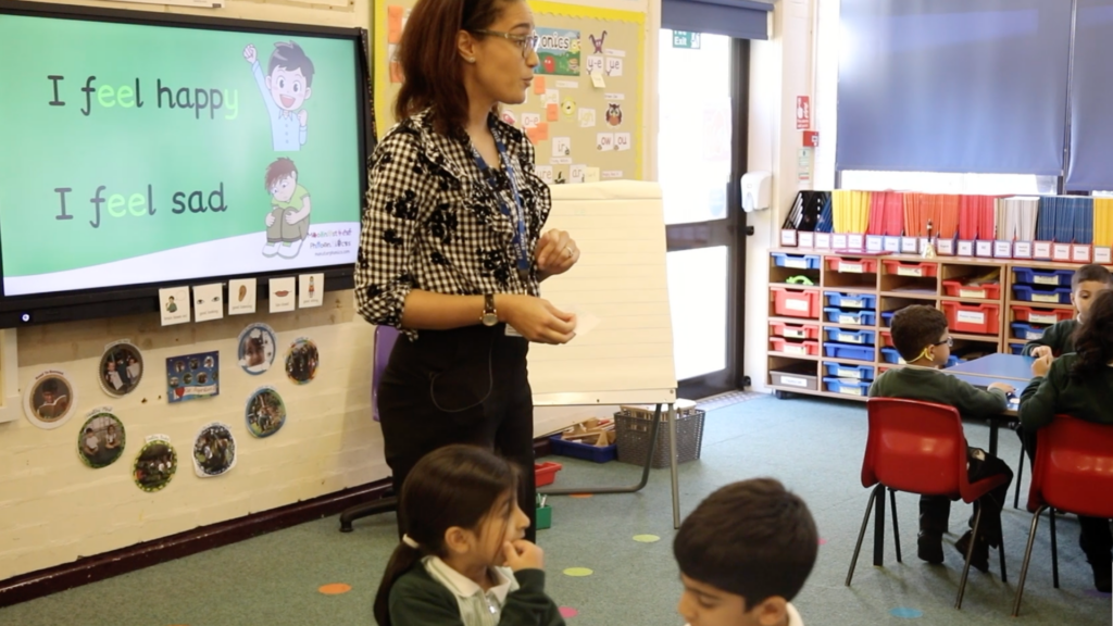 Teacher in a classroom teaching monster phonics